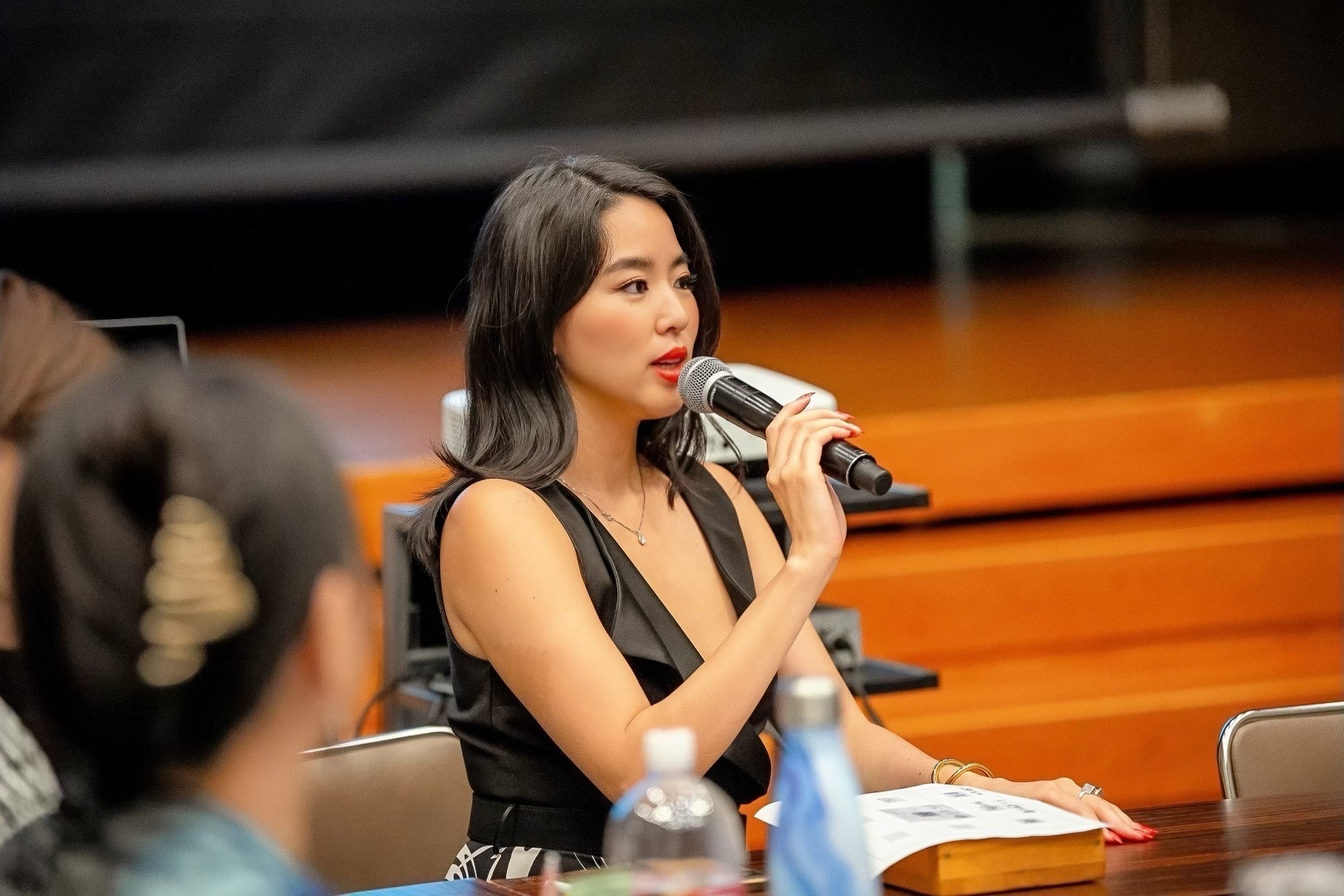 Woman speaking into microphone